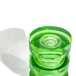 Close up view of a green side table made from solid cast resin by Ian Cochran. Represented by Tuleste Factory, an art & design gallery in Chelsea, New York city.