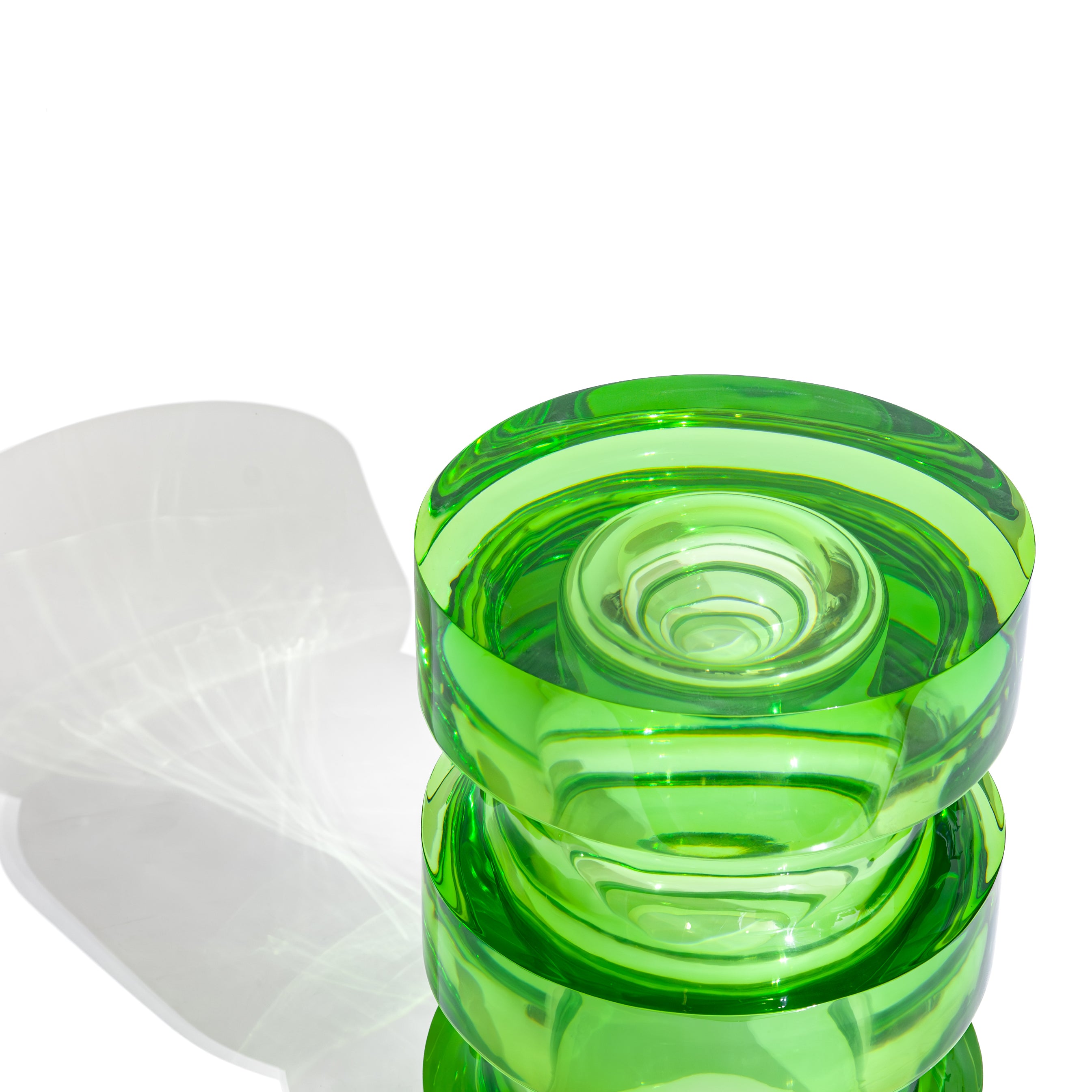 Close up view of a green side table made from solid cast resin by Ian Cochran. Represented by Tuleste Factory, an art & design gallery in Chelsea, New York city.