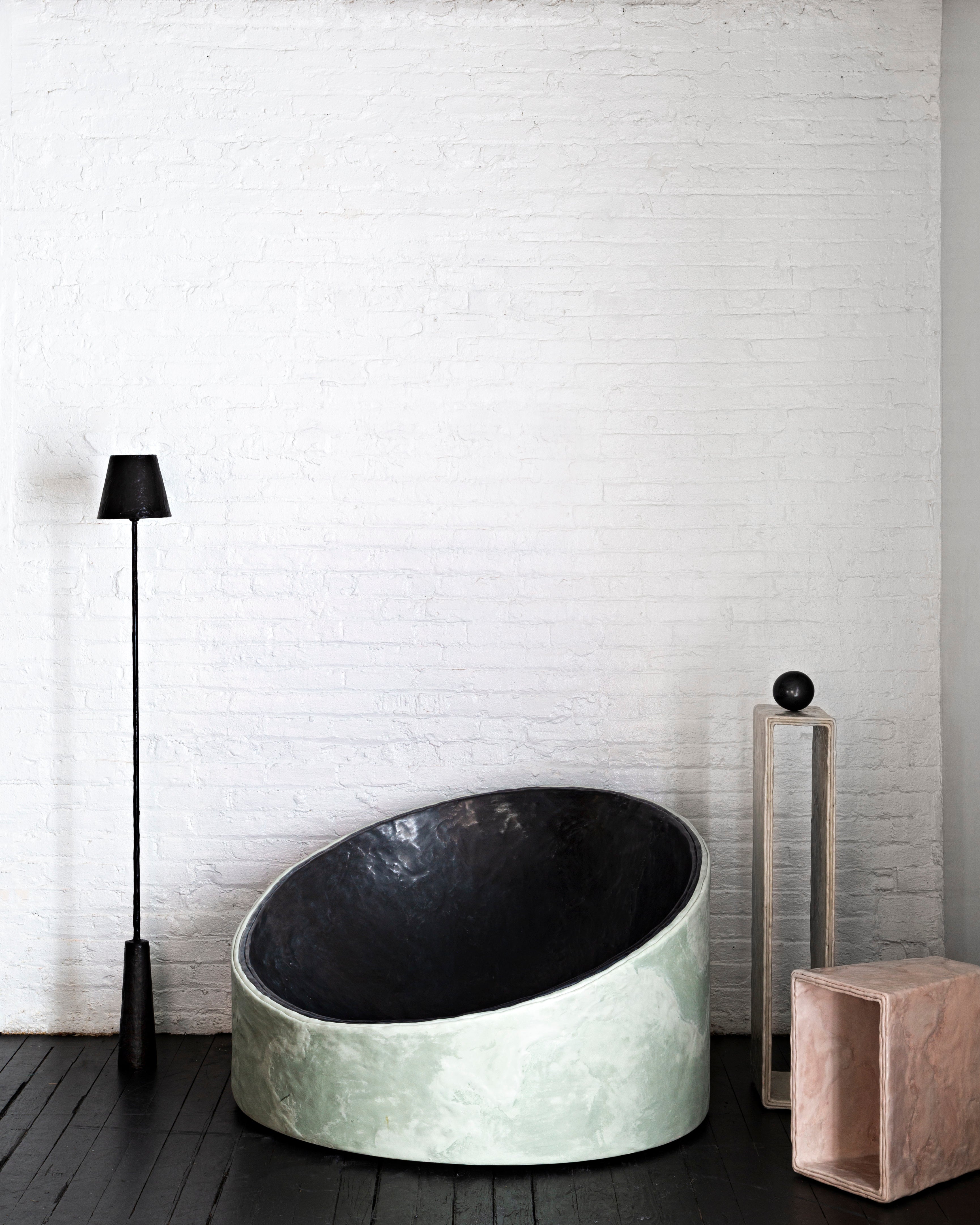 The Plane side table by Bailey Fontaine is hand sculpted from cement. On display at Tuleste Factory, a non-traditional gallery in New York City.