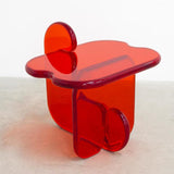 Front view of unique contemporary and playful transparent side table in resin by Ian Alistair Cochran. Represented by collectible design gallery Tuleste Factory in Chelsea, NYC.