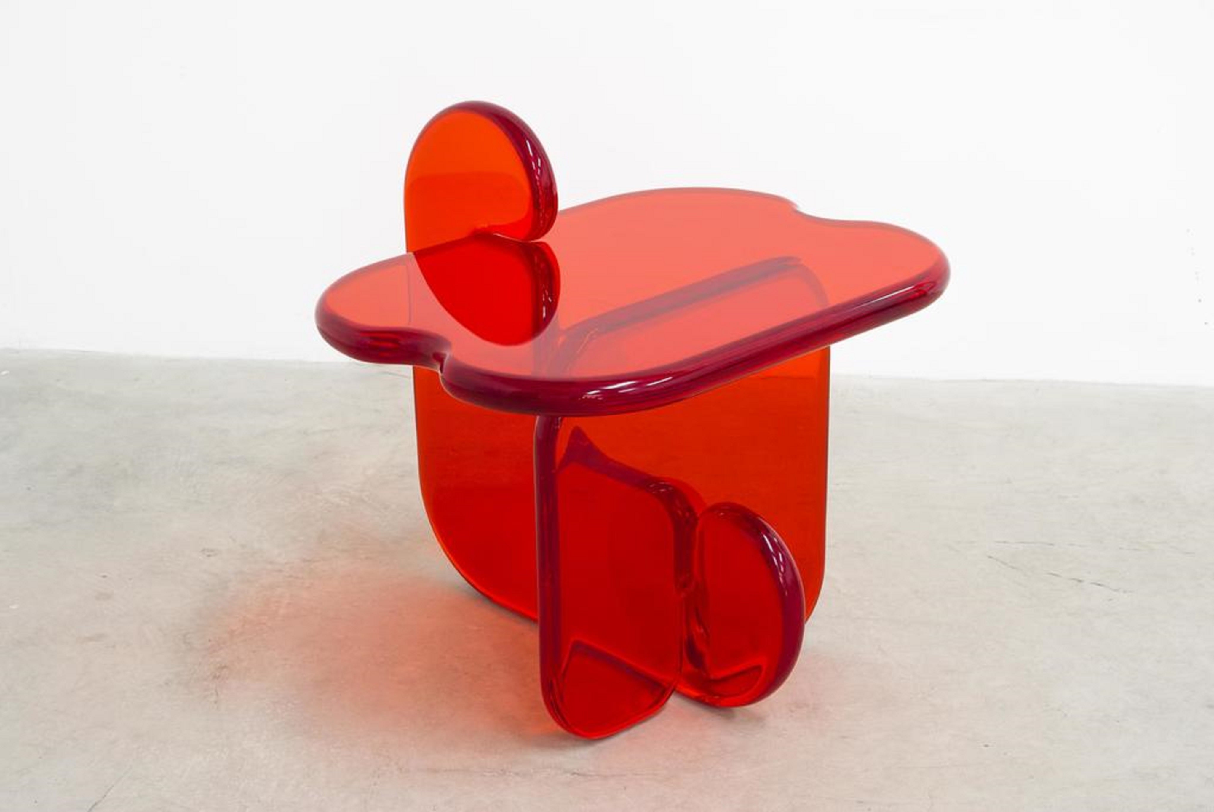 Front view of unique contemporary and playful transparent side table in resin by Ian Alistair Cochran. Represented by collectible design gallery Tuleste Factory in Chelsea, NYC.