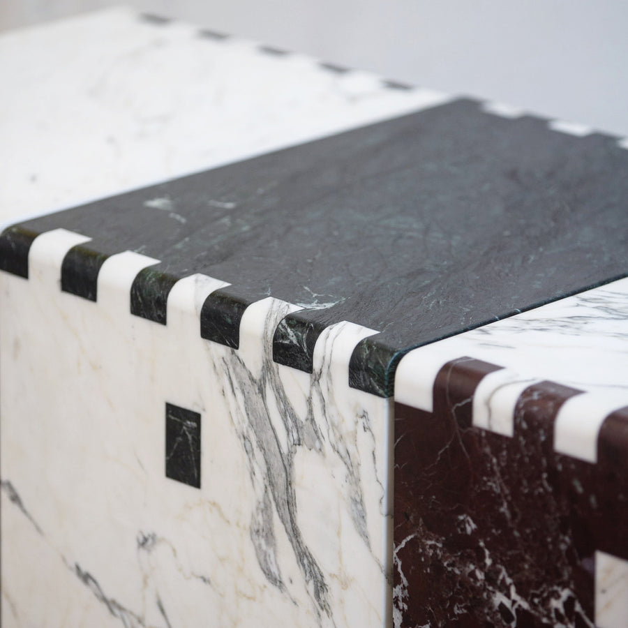 Black and white marble inlay/jointed side table and stool by furniture designer Christopher Miano. Represented by collectible design gallery Tuleste Factory in New York City.
