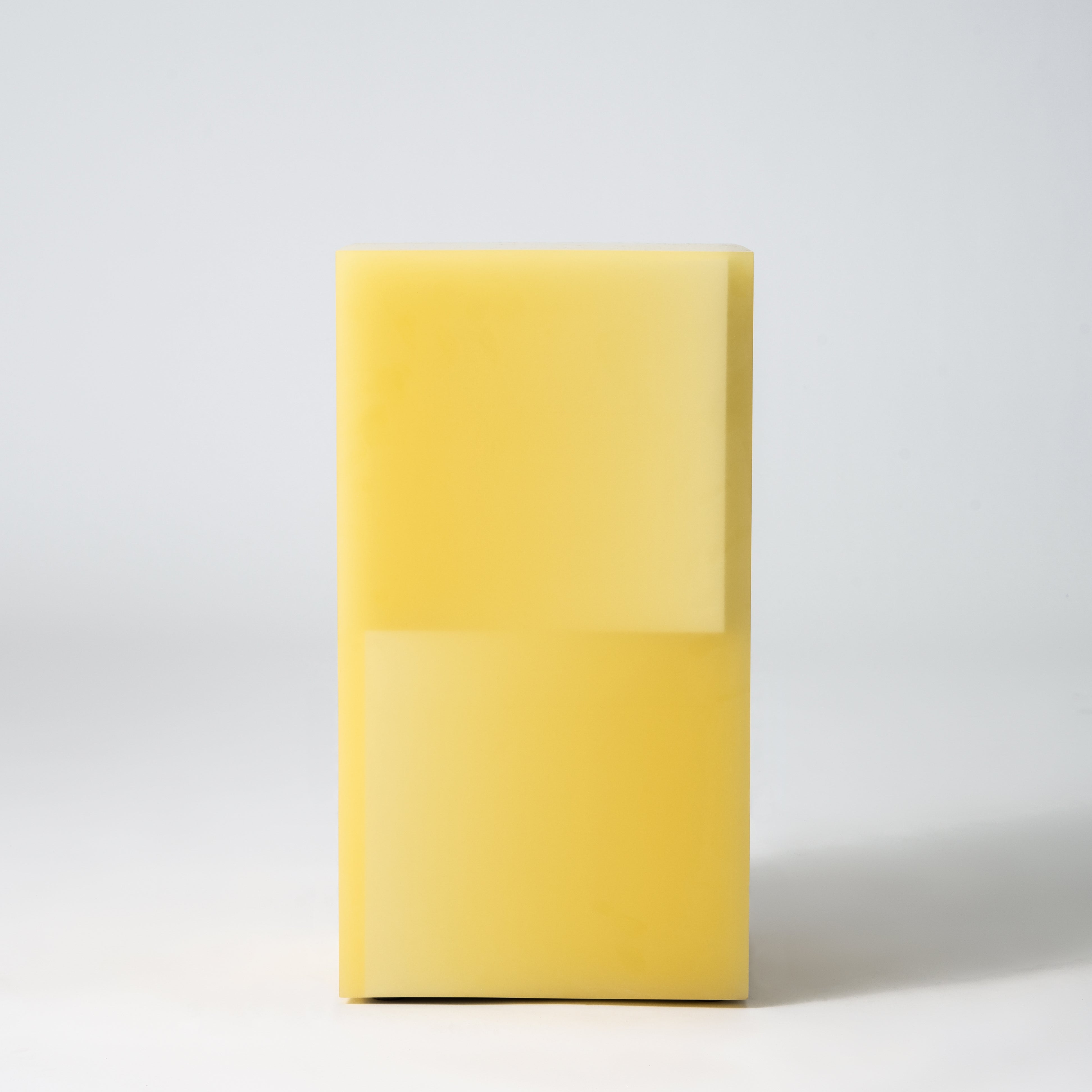 Stool functions as side table, made from resin.