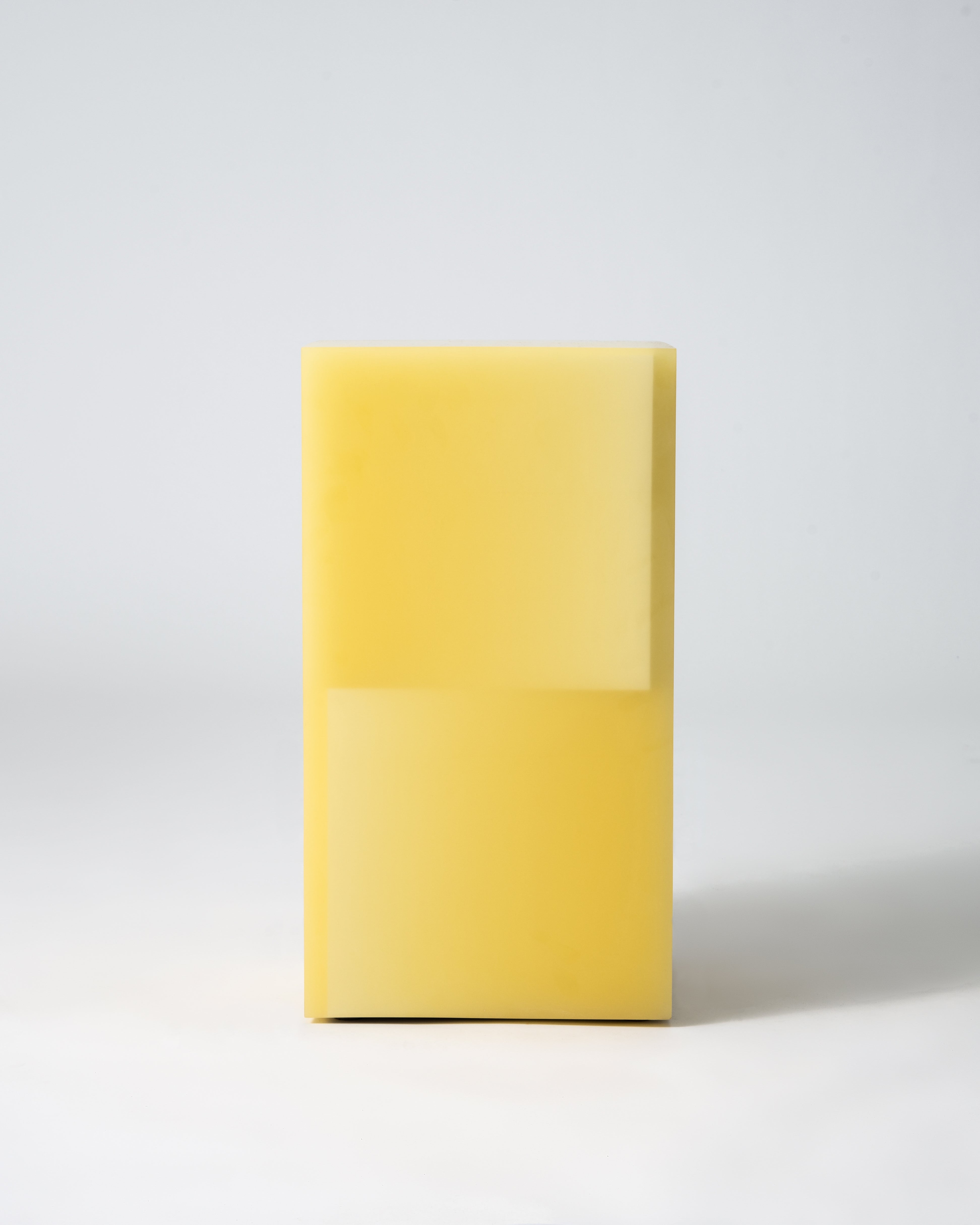 Stool functions as side table, made from resin.