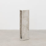 Side view of tall minimalist hand sculpted designer side table by artist Bailey Fontaine. Represented by design gallery Tuleste Factory in New York City.