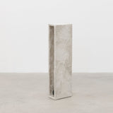 Side view of tall minimalist hand sculpted designer side table by artist Bailey Fontaine. Represented by design gallery Tuleste Factory in New York City.