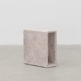 Side view of minimalist hand sculpted side table by artist Bailey Fontaine. Represented by design gallery Tuleste Factory in New York City.