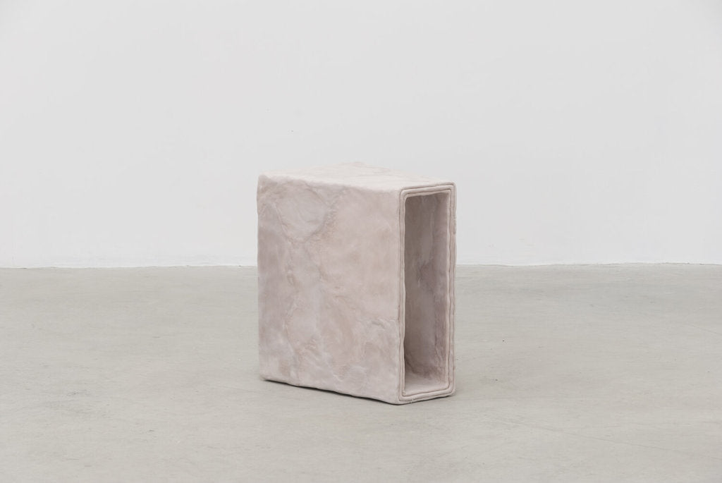 Side view of minimalist hand sculpted side table by artist Bailey Fontaine. Represented by design gallery Tuleste Factory in New York City.
