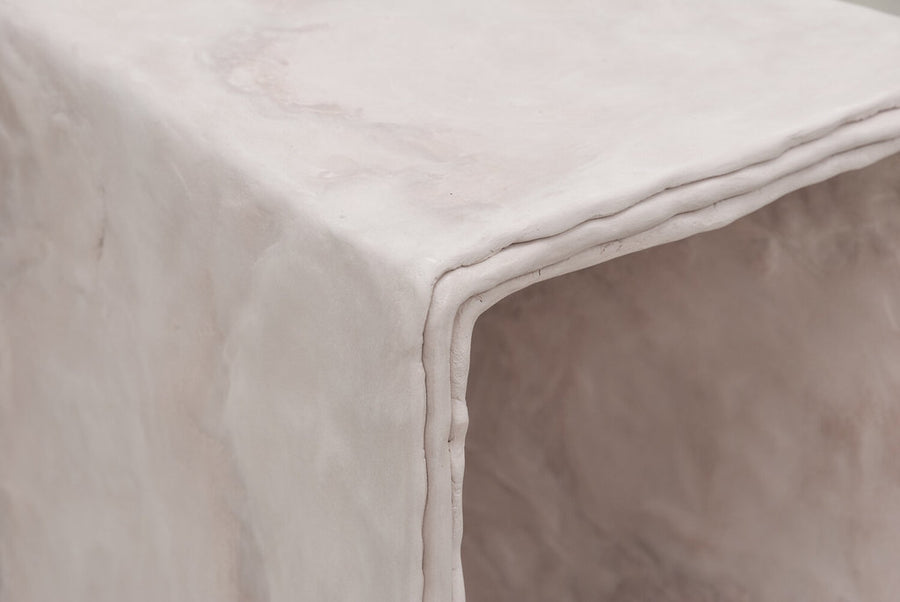 Close up detail of minimalist hand sculpted art side table by artist Bailey Fontaine. Represented by design gallery Tuleste Factory in New York City.