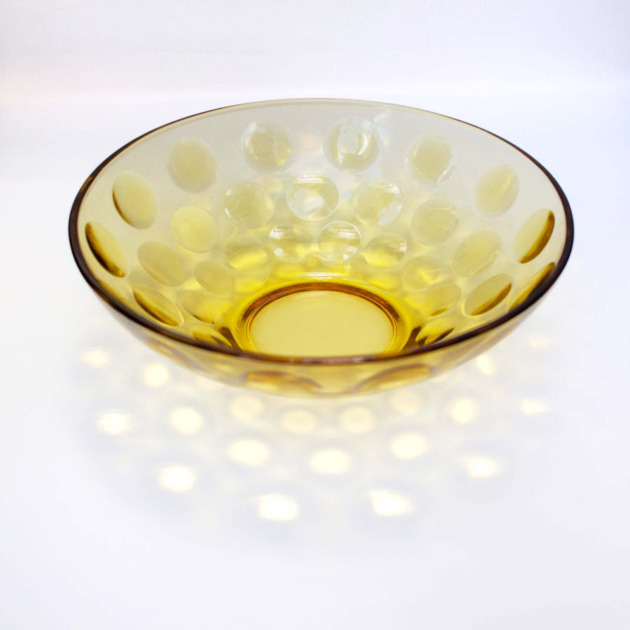 Yellow crystal bowl with circle indentations decorating the outer layer. Perfect for holding fruits, salads, or just a centerpiece decoration.